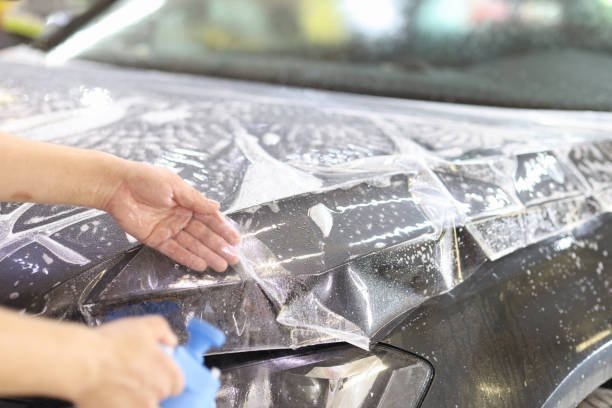 Applying a section of the best ppf for professionals to a vehicle bonnet panel